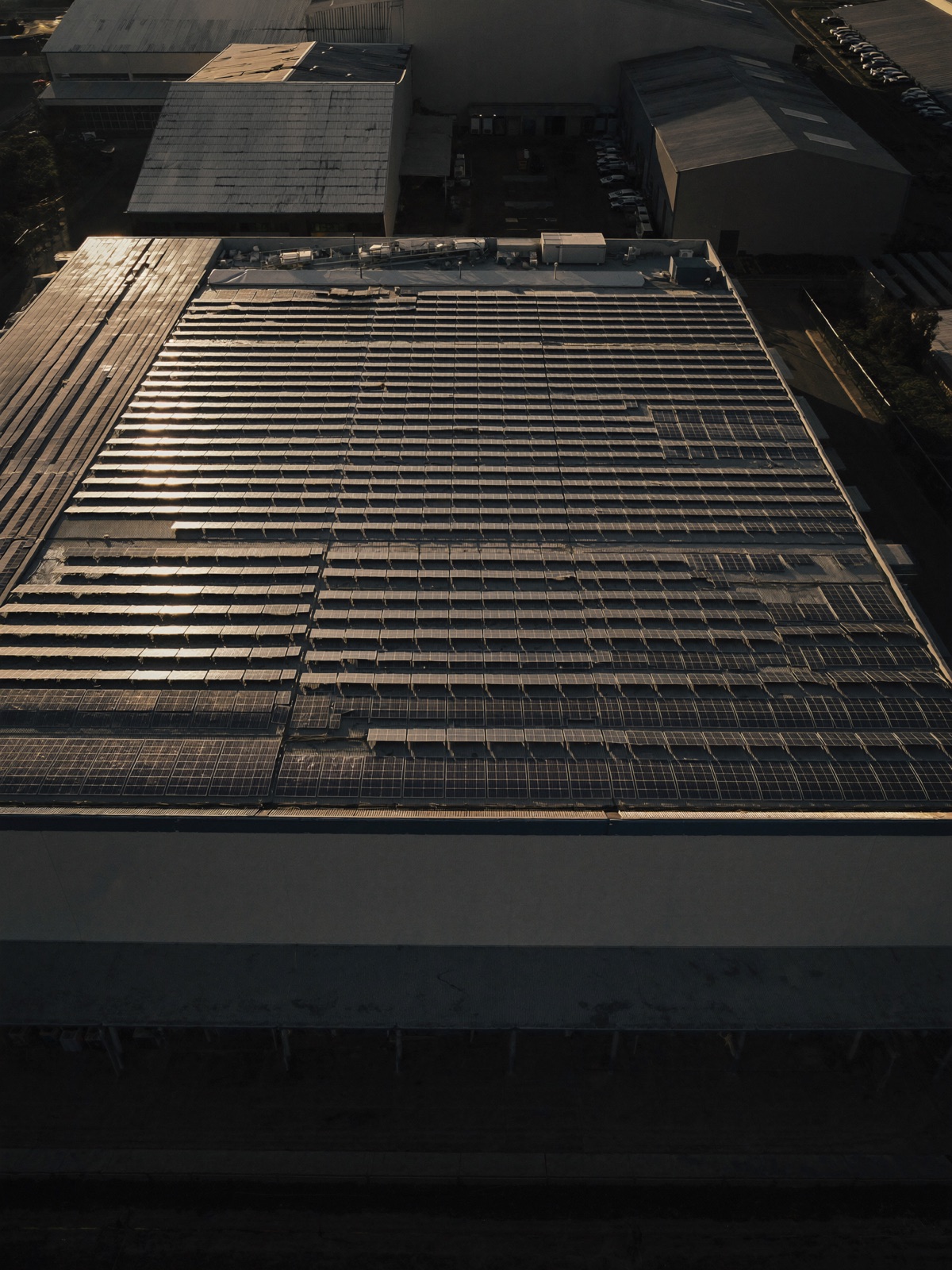 Commercial rooftop solar array at dusk